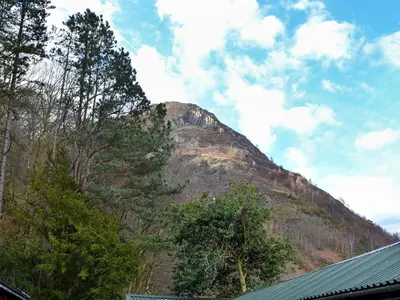 a mountain in the distance with trees and a building at Squirrels Retreat - Uk30821 in Braithwaite