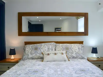 a bedroom with a bed with a mirror above it at The Dairy - Uk30867 in St Bees