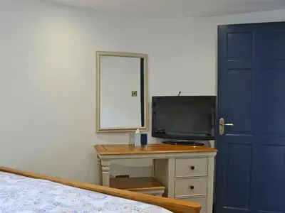 a bedroom with a bed and a tv on a table at The Dairy - Uk30867 in St Bees
