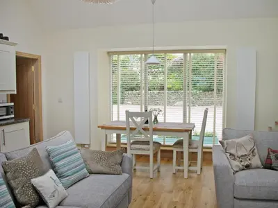 a kitchen and dining room with a table and chairs at Swallows in Girthon