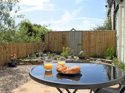 a table with bread and two glasses of orange juice at Swallows in Girthon