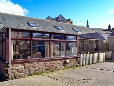 a house with glass windows on the side of it at The Milking Parlour - Uk30866 in St Bees