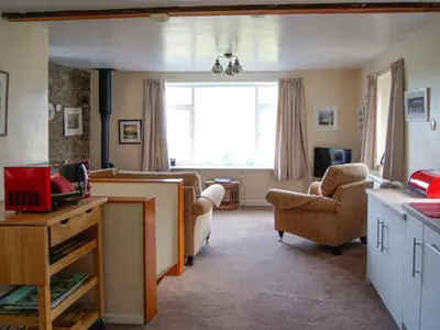 a living room with a couch and a window at The Coach House - Uk30813 in Braithwaite