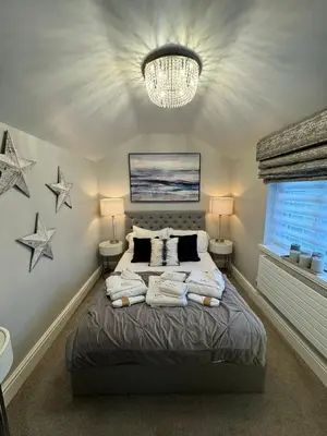 a bedroom with a bed with stars on the wall at Marys Cottage, Grasmere, Dog Friendly, Hot Tub in Grasmere