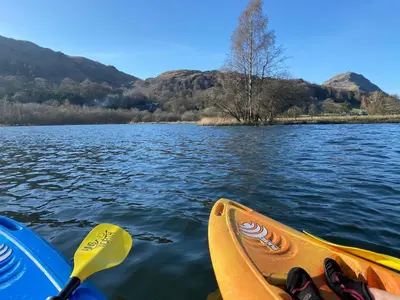 a pair of shoes in a kayak on a lake at Marys Cottage, Grasmere, Dog Friendly, Hot Tub in Grasmere