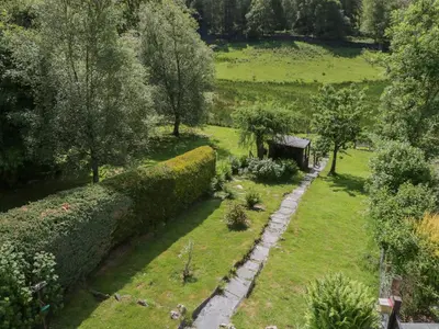 an overhead view of a garden with bushes and trees at Acorn Cottage in Coniston