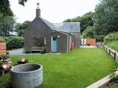 a small house with a yard with a fire pit at Rose Blair Lodge - Uk31045 in Portpatrick