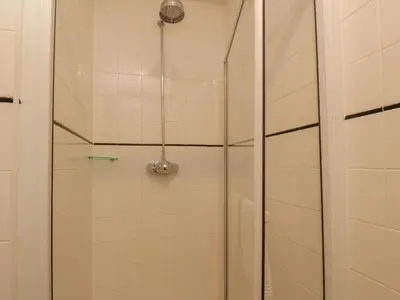 a shower in a bathroom with a glass door at The Precinct House in Newton Stewart