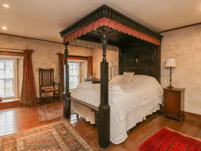 a bedroom with a large bed in a room at The Pend in Newton Stewart