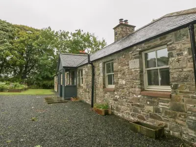 an old stone building with a door and windows at Faldarroch Farm in Newton Stewart