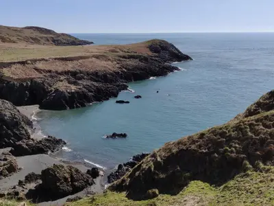 a view of a beach with rocks in the water at The Royal Apartment - Uk31086 in Portpatrick