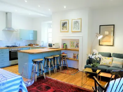 a kitchen and living room with a couch and a table at The Royal Apartment - Uk31086 in Portpatrick
