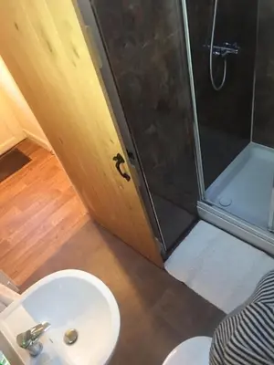 a bathroom with a shower and a toilet and a sink at The Stables in Castle Douglas
