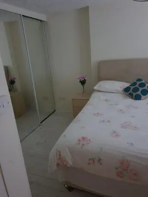 a bedroom with a bed and a glass wall at RoSE COTTAGE THREE BEDROOM HOUSE WITH PARKING Christmas Special in Carsphairn