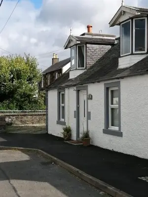 a white house with a driveway in front of it at RoSE COTTAGE THREE BEDROOM HOUSE WITH PARKING Christmas Special in Carsphairn