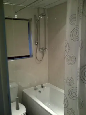 a bathroom with a tub and a toilet and a shower at Lavender Cottage with Parking and Beautiful Views Christmas Special in Carsphairn