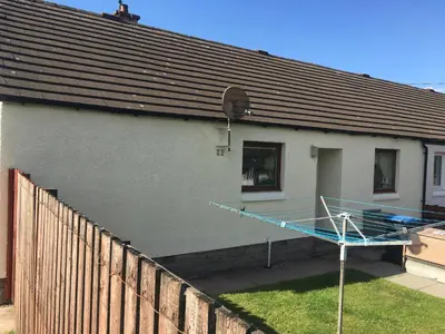 a house with a basketball hoop on the side of it at Lavender Cottage with Parking and Beautiful Views Christmas Special in Carsphairn