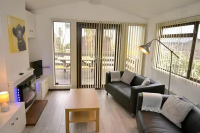 a living room with a couch and a table at Bunnahabhain 5 - Farm Stay - Stunning sea and rural views in Stranraer