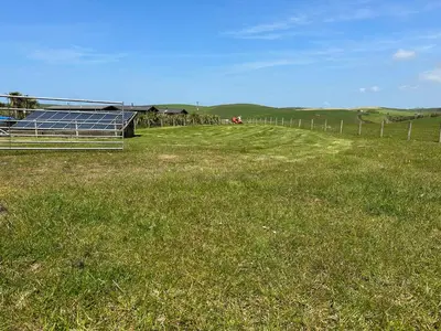 a field with a solar panel in the grass at Ardbeg 4 - Farm Stay with Sea Views across to Northern Ireland in Stranraer