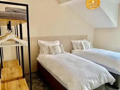 a bedroom with two beds and a bunk bed at 5a Bank Street in Keswick