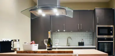 a kitchen with a bottle of wine and a light at 5a Bank Street in Keswick