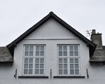a large window on the side of a white house at 5a Bank Street in Keswick