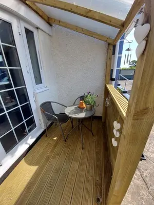 a small table on the balcony of a tiny house at Hadrians wall studio in Carlisle