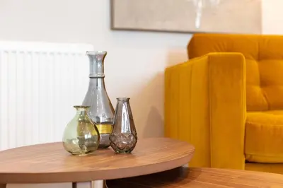 three glass vases sitting on top of a table at Seafield House - Donnini Apartments in Ayr