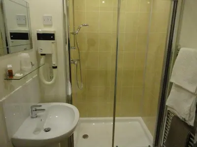 a bathroom with a shower and a sink and a shower at Arden House Hotel in Kirkcudbright