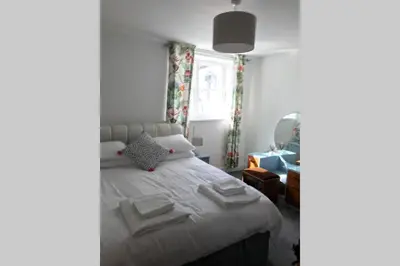 a bedroom with a bed and a window at Albion Cottage in Cockermouth