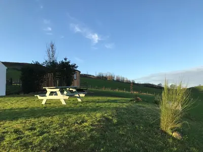 a picnic table in the grass in a field at Jacquie's B&B -Dumfries-Room with a view in Dumfries