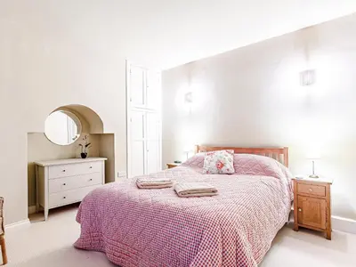 a bedroom with a bed and a dresser and a mirror at Sharrow View in Watermillock