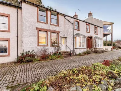 an old brick house with a cobblestone driveway at Sharrow View in Watermillock