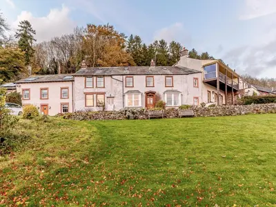 a large house on a hill with a yard at Sharrow View in Watermillock