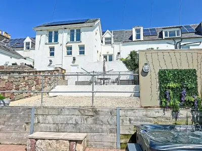 a house with a gate and a bench in front of it at Ardstinchar Mews in Ballantrae