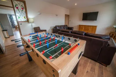 a living room with a large table with a pool table at The Haven Keswick - Spacious Central Apartment in Keswick