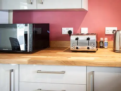 a microwave oven sitting on top of a counter at The Grooms Cottage in Mauchline