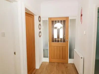a hallway with a wooden door in a house at Tarnacrye in Annan