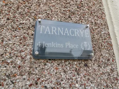 a sign that reads tamaragency jewishing place at Tarnacrye in Annan