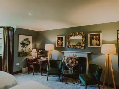 a room with a bed and a desk and a fireplace at Coachman in Enoch