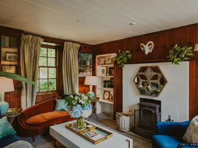 a living room with a couch and a fireplace at Coachman in Enoch