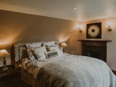 a bedroom with a large bed with pillows at Coachman in Enoch