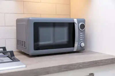a microwave oven sitting on top of a counter at Seaforth Suite - Donnini Apartments in Ayr