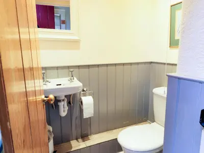 a bathroom with a toilet and a sink at The Coach House in Newton Stewart