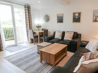 a living room with a couch and a table at Simply Suite in Castle Douglas