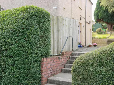 a set of stairs in front of a fence at Simply Suite in Castle Douglas