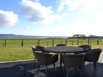 a table and chairs with a view of a field at Dinduff Lodge in Challoch