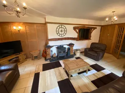 a living room with a couch and a fireplace at Country Cottage Sleeps 6 w Hot Tub & Dog-Friendly in Moniaive