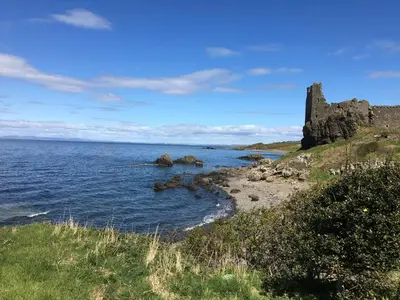 a castle on the shore of a body of water at Kincraig Apartment in Ayr