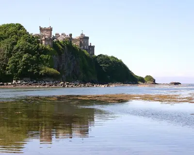 a castle on an island in a body of water at Kincraig Apartment in Ayr